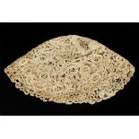 An ivory-toned lace skull cap, possibly 16th/17th century, worked with overall scrolling foliage,