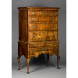 A George I walnut chest-on-stand with feather and crossbanded decoration, the cavetto moulded