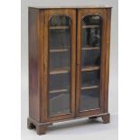 A Victorian mahogany bookcase, enclosed by two glazed doors, on bracket feet, height 125cm, width