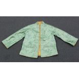 A mid-20th Century Japanese golden and green patterned silk reversible lady's jacket, length 65cm,