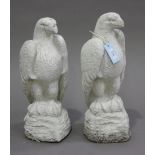 A pair of 20th century white painted cast composition garden models of eagles, height 47cm.