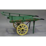 A 20th century green painted street vendor's style trolley with slatted top and spoked wheels,