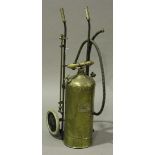 An early 20th century brass garden sprayer, the cylinder bearing maker's plaque inscribed 'The