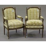 A pair of late 19th/early 20th century Louis XVI style walnut fauteuil armchairs, the frames