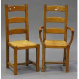 A set of eight modern ash ladder back chairs with rush seats, on block legs, comprising one carver