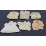 A quantity of mostly early 20th century infants' clothing, including various silk dresses, nylon