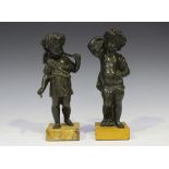 A pair of mid-19th century Continental green/brown patinated cast bronze figures of putti emblematic