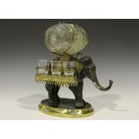 An early 20th century patinated spelter and gilt brass liqueur stand in the form of an elephant, its