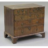 A George I walnut chest of two short and three long drawers with crossbanded decoration, the top