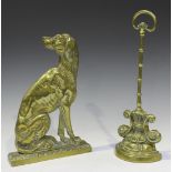 A Victorian cast brass doorstop in the form of a seated dog, height 32cm, together with another