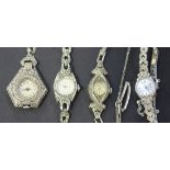 A silver and marcasite lady's brooch watch and three marcasite ladies' bracelet wristwatches.