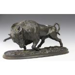A 19th century Russian black patinated cast iron model of a bison with its head held low in an