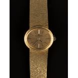 A Baume & Mercier 18ct gold lady's bracelet wristwatch, the signed oval bark textured dial with
