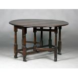 A George I red walnut oval gateleg dining table, the drop-flap top raised on turned and block legs