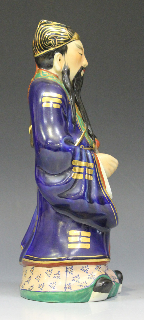 A Chinese porcelain figure of an immortal, 20th century, modelled standing wearing a blue robe - Image 5 of 7