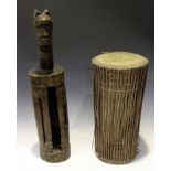 A West African wooden split drum with a carved head finial, height 77cm, together with a Nigerian