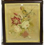 A Victorian needlework panel depicting a parrot and flowers, 69cm x 60cm, within a simulated