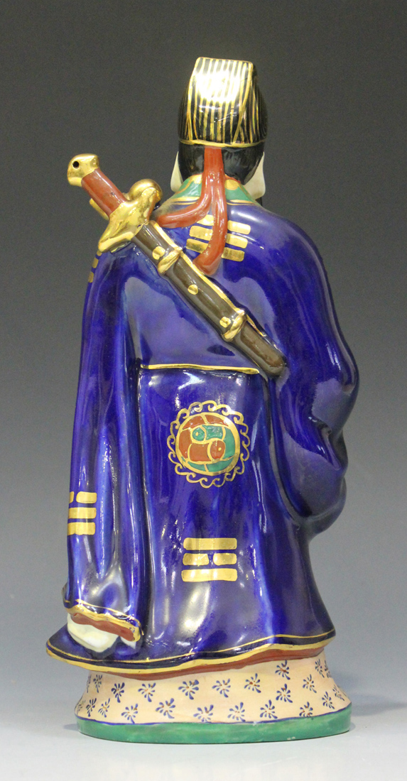A Chinese porcelain figure of an immortal, 20th century, modelled standing wearing a blue robe - Image 6 of 7