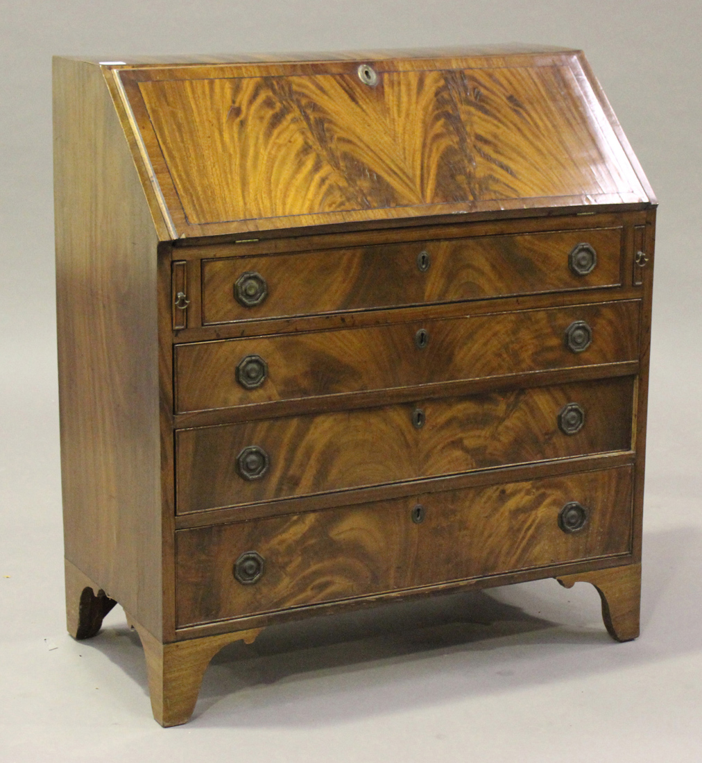 A late George III figured mahogany bureau, the fall flap above four long drawers, on bracket feet,