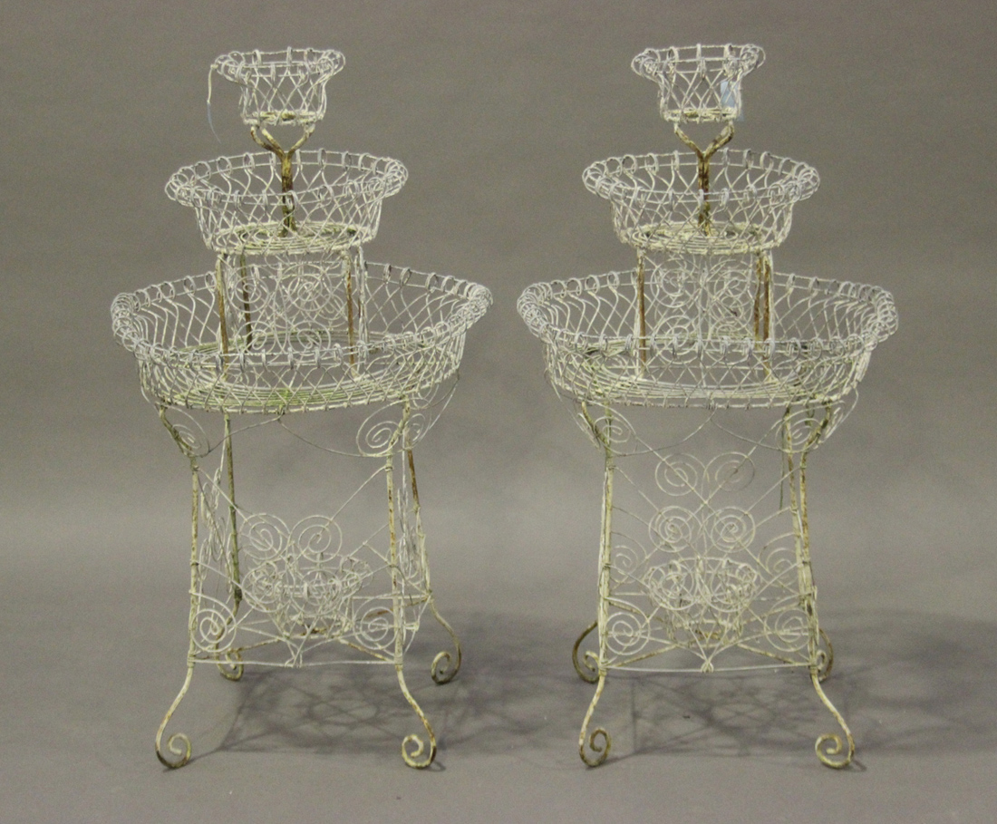 A pair of late 19th/early 20th century wirework three-tier plant stands of circular form, height