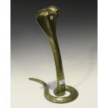 An early 20th century Indian brass lamp in the form of a cobra with overall engraved decoration,