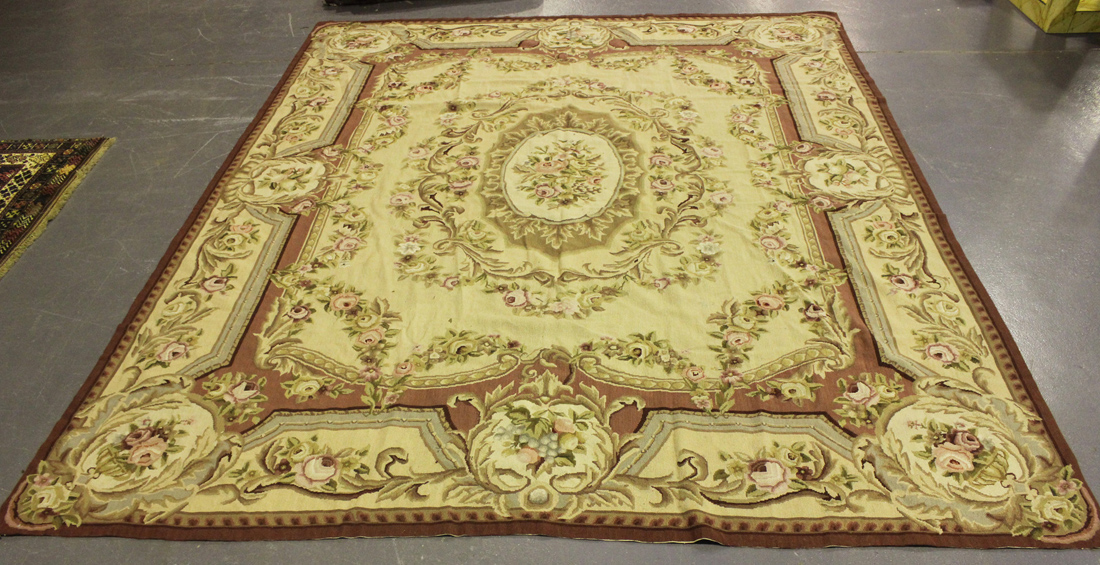 A Savonnerie style flatweave carpet, late 20th century, the ivory field with a foliate medallion,