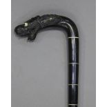 An early 20th century Ceylonese carved ebony walking stick, the handle in the form of a dragon's