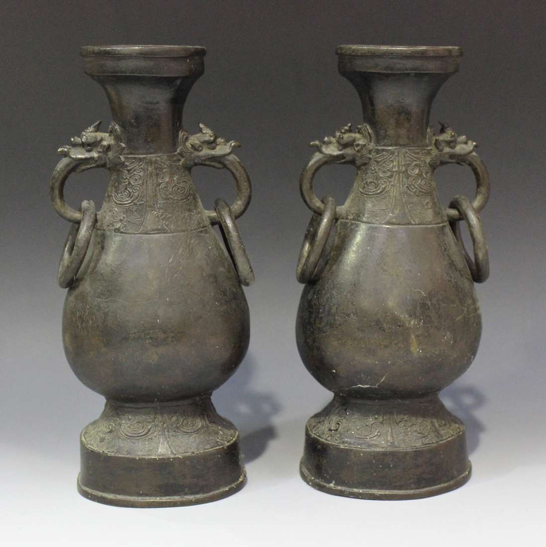 A pair of Chinese archaistic bronze hu vases, early Ming dynasty, each pear form body cast in relief