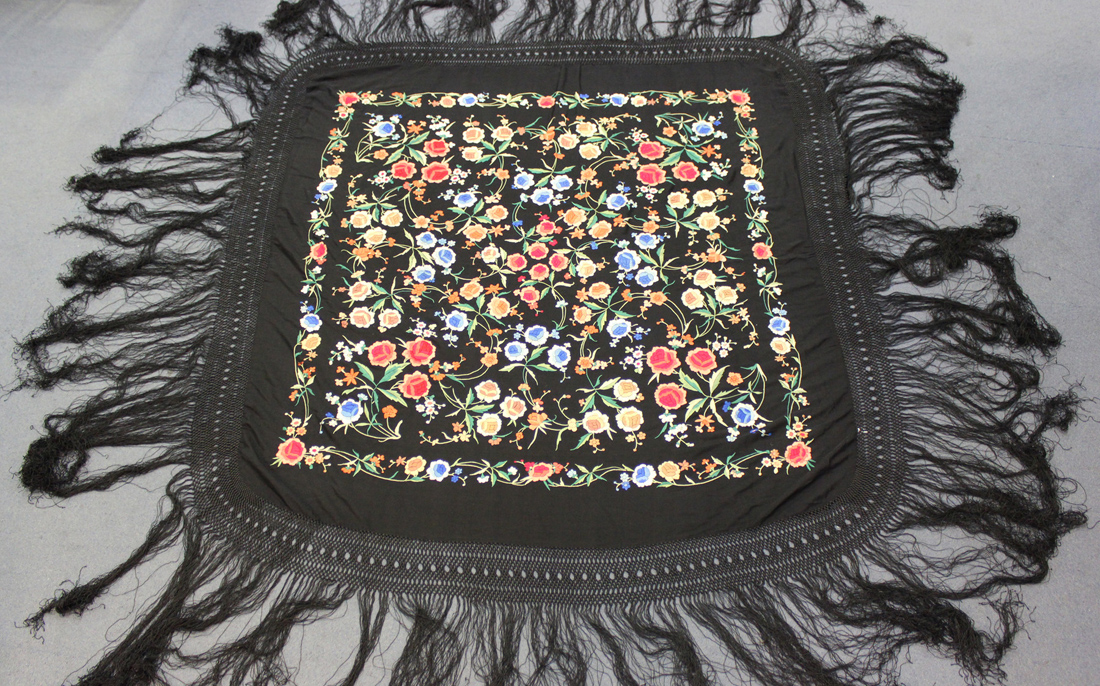 Two Chinese black silk embroidered shawls, early 20th century, each finely worked in coloured