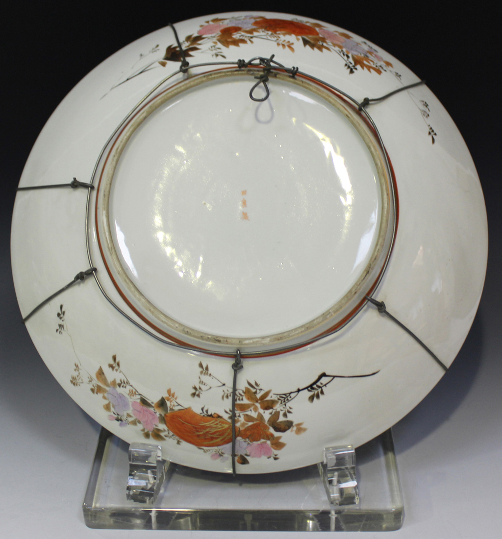 A Japanese Kutani porcelain charger, Meiji period, painted and gilt with figures in a lakeside - Image 2 of 3