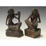 A pair of 20th century Balinese carved hardwood figures of semi-clad maidens seated upon carved