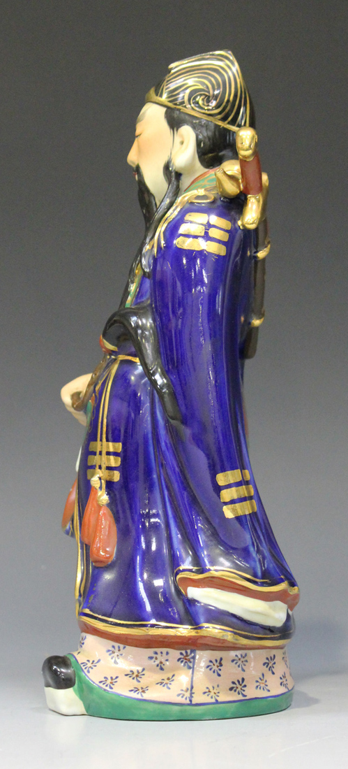 A Chinese porcelain figure of an immortal, 20th century, modelled standing wearing a blue robe - Image 7 of 7