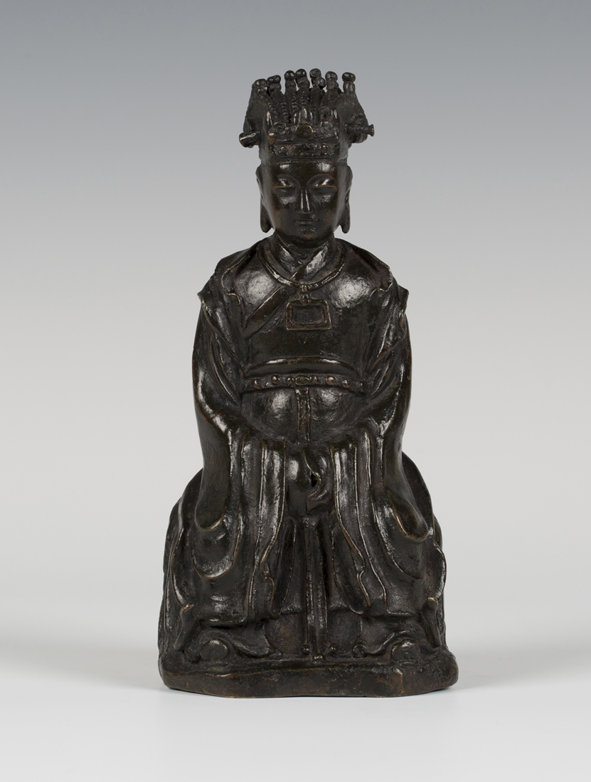 A Chinese brown patinated bronze figure of a seated female official, late Ming dynasty, modelled