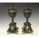 A pair of late 19th century French cast spelter and green marble ornamental urns with gilt metal