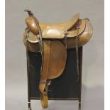 A mid-20th century American Whitman of Cincinnati brown leather Western saddle with wooden stirrups,