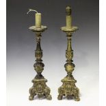 A pair of 18th century giltwood candlesticks with turned and carved knop stems, raised on triform