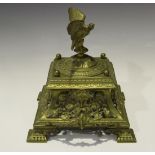 A late Victorian cast brass ink stand, the hinged lid with an eagle surmount above a pierced fruit