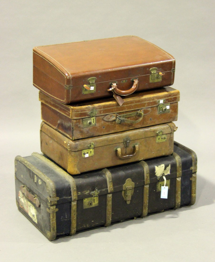 An early 20th century wooden bound travelling trunk, width 94cm, together with three brown leather