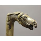 A late 19th century Greek carved fruitwood walking stick, the handle in the form of a horse's head