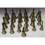 A set of twenty-five 20th century brass musical hand bells, ranging from G to G, all fitted with