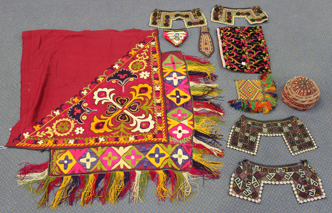 A quantity of mostly 20th century Indian needlework textiles, including clothing and embroidered