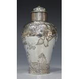 A George II silver tea caddy of high shouldered baluster form with domed lid, decorated in relief
