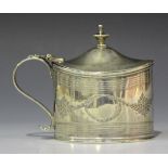 A George III silver oval mustard, the hinge lid with urn finial, the sides bright cut engraved