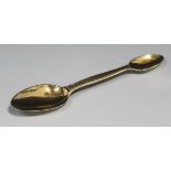 A Victorian silver gilt double ended medicine spoon with engine turned decoration, London 1856 by