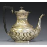 A George V silver hot water pot of half-reeded cushion form, Birmingham 1912 by Charles Weale,
