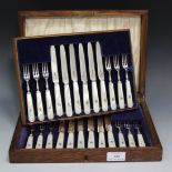 A set of twelve George V silver and mother-of-pearl dessert knives and forks, Sheffield 1930 by