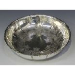 A George VI silver strawberry dish of lobed circular form, the wavy rim engraved with a shell