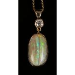 A gold, opal and diamond pendant, mounted with the oval opal surmounted by a circular cut diamond,