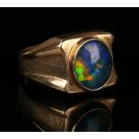 A gold ring, mounted with an oval opal doublet between textured shoulders, detailed '9ct', ring size