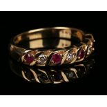 A 9ct gold, diamond and ruby seven stone half-hoop ring, mounted with three circular cut diamonds